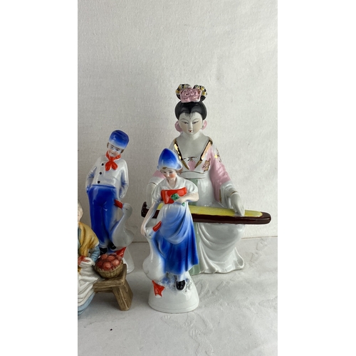 58 - Collection of decorative figurines including porcelain girls, an elderly woman, a unicorn and fairy,... 