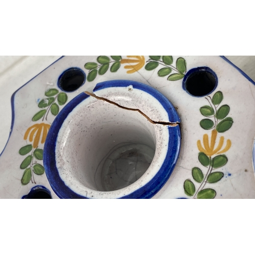 62 - French pottery set, including a jug and a candleholder, with hand-painted floral designs. Marked 