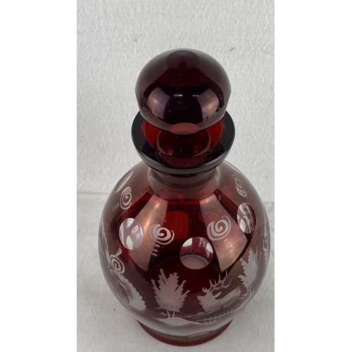 64 - Bohemian Ruby Red Cut-to-Clear Glass Decanter with Stopper. Features intricate etched designs of wil... 