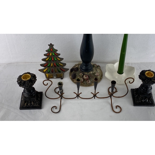 70 - Assorted vintage candle holders and candle-related decor, including metal, ceramic, and wooden piece... 