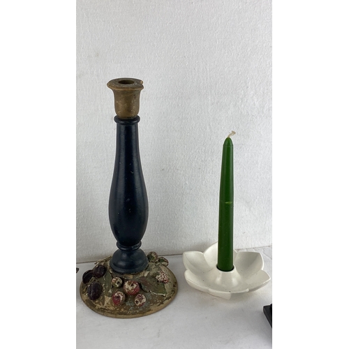 70 - Assorted vintage candle holders and candle-related decor, including metal, ceramic, and wooden piece... 