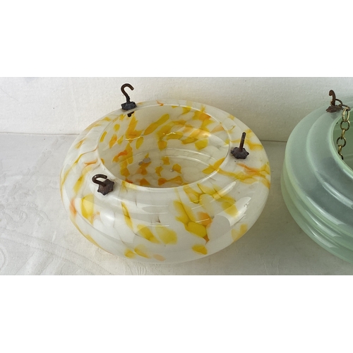 76 - Pair of vintage glass 'Fly Catcher' hanging light shades. One features a yellow and orange swirl des... 