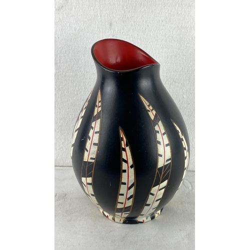 77 - Cobridge Stoneware vase featuring black matte finish with intricate feather motif in cream, red, and... 