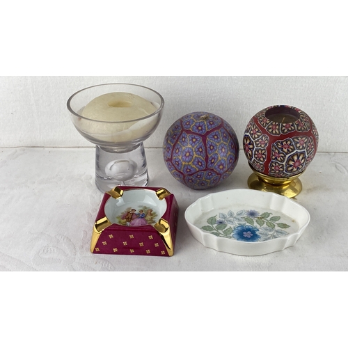 84 - Assorted decor items include two patterned candle holders, a glass candle holder with a candle, a re... 