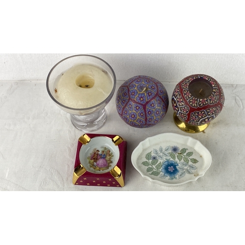 84 - Assorted decor items include two patterned candle holders, a glass candle holder with a candle, a re... 