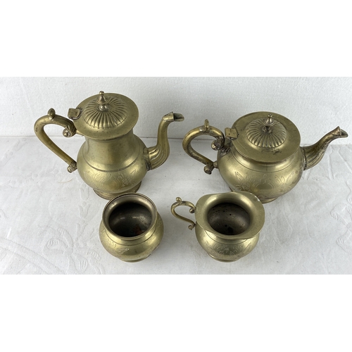 85 - Brass tea set comprising a teapot, coffee pot, creamer, and sugar bowl, each adorned with engraved f... 