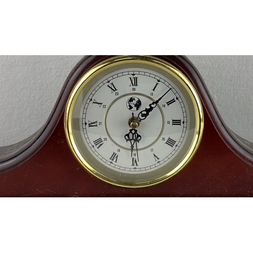 88 - Wooden mantel clock with rounded arch design, brass bezel, Roman numerals, and black intricate hands... 