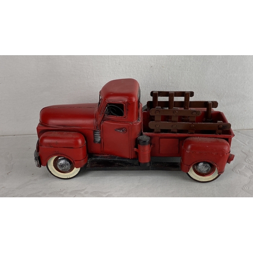 99 - Red pickup truck model, featuring white-rimmed tires and painted accents.