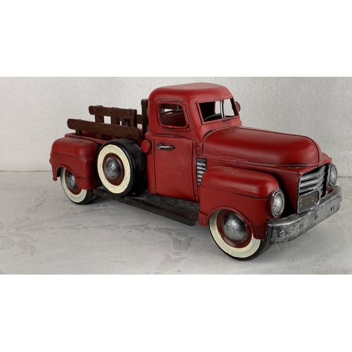 99 - Red pickup truck model, featuring white-rimmed tires and painted accents.