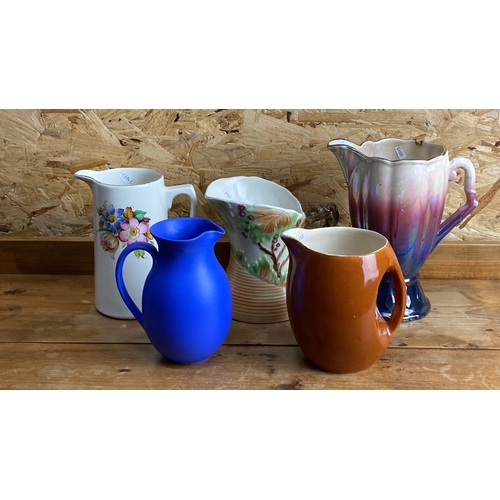 255 - Set of five vintage ceramic pitchers in various styles and colors, featuring floral and tree branch ... 