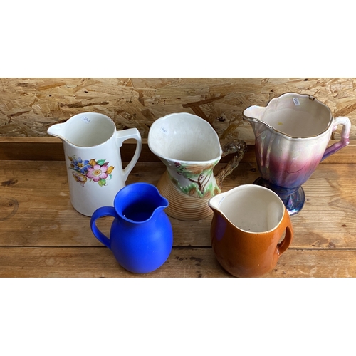 255 - Set of five vintage ceramic pitchers in various styles and colors, featuring floral and tree branch ... 