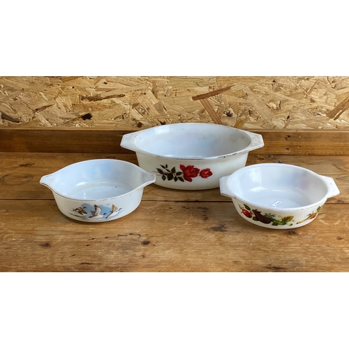 262 - Set of vintage Pyrex mixing bowls with distinct floral and avian designs. Made of classic white glas... 