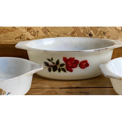 262 - Set of vintage Pyrex mixing bowls with distinct floral and avian designs. Made of classic white glas... 