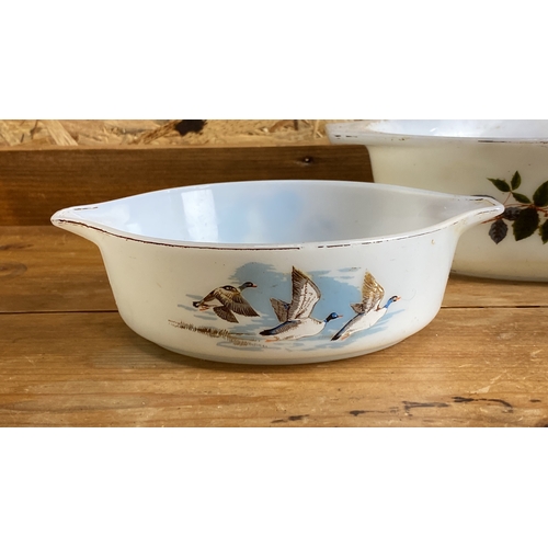 262 - Set of vintage Pyrex mixing bowls with distinct floral and avian designs. Made of classic white glas... 