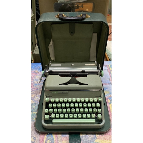 271 - Vintage Hermes 2000 typewriter features a sleek design with mint green keys and is housed in a match... 