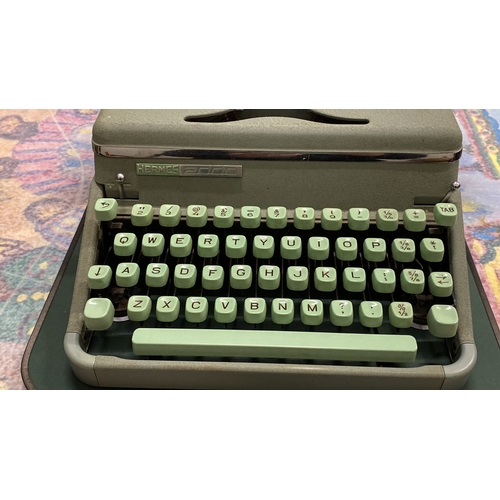 271 - Vintage Hermes 2000 typewriter features a sleek design with mint green keys and is housed in a match... 