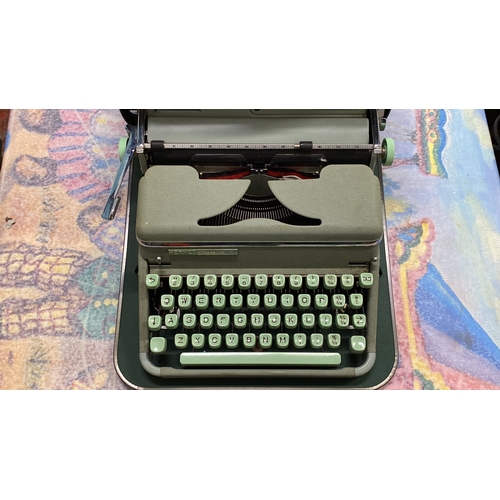 271 - Vintage Hermes 2000 typewriter features a sleek design with mint green keys and is housed in a match... 