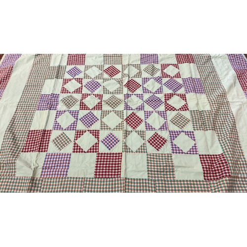 285 - Quilt features a checkerboard pattern with multi-colored plaid squares and white fabric inserts, tri... 