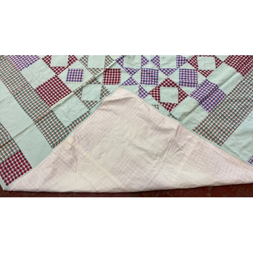 285 - Quilt features a checkerboard pattern with multi-colored plaid squares and white fabric inserts, tri... 