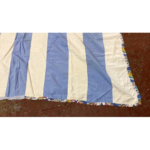 287 - Blue and white striped quilt with a patterned border, featuring alternating solid color strips. Inte... 