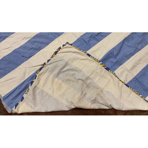 287 - Blue and white striped quilt with a patterned border, featuring alternating solid color strips. Inte... 