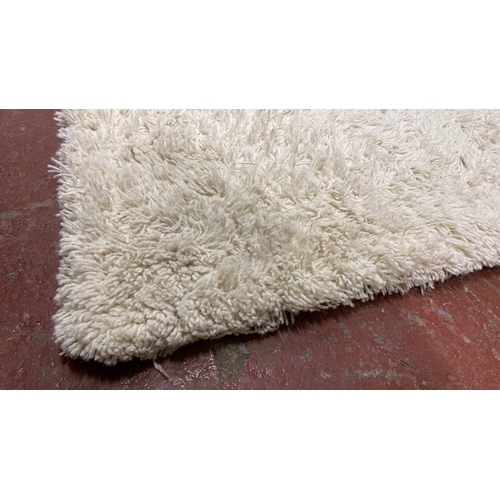 291 - Plush white shaggy rug with a high-pile texture.