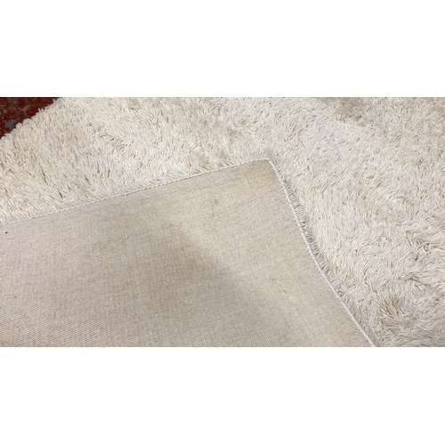 291 - Plush white shaggy rug with a high-pile texture.