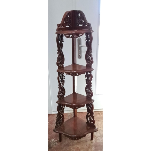 107 - Corner whatnot stand, made of mahogany, features intricate carved floral and vine motifs, with four ... 