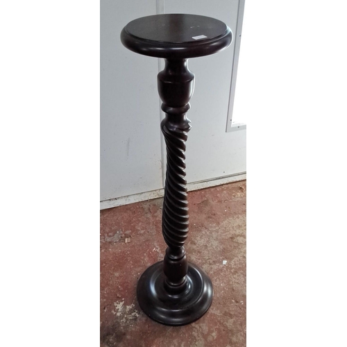 117 - Twisted wooden plant stand with a dark mahogany finish, featuring a round top and a sturdy base.