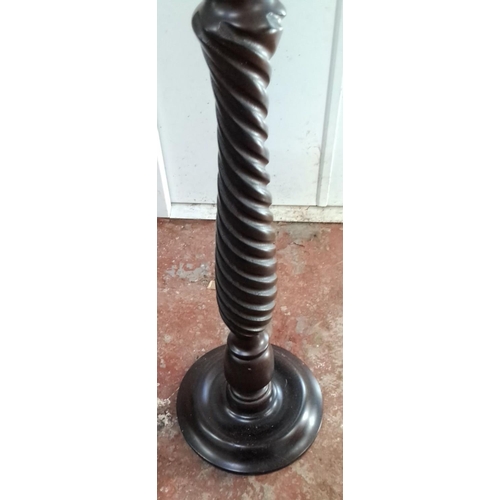 117 - Twisted wooden plant stand with a dark mahogany finish, featuring a round top and a sturdy base.