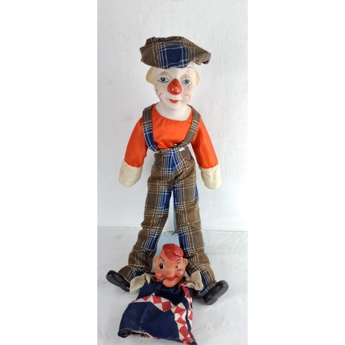 123 - Vintage clown doll with cloth overalls and cap, featuring a painted porcelain face. Includes an addi... 