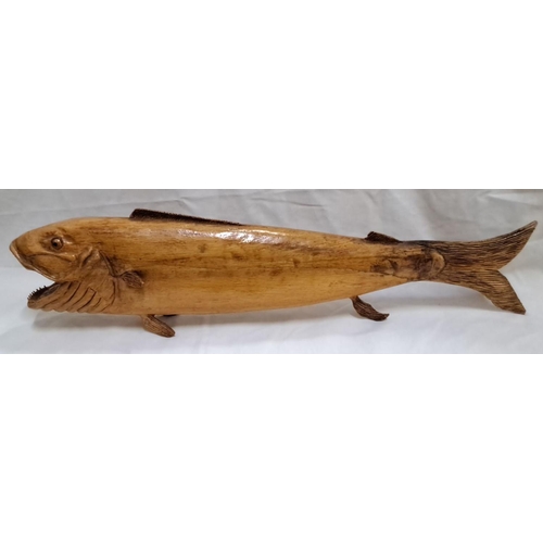 126 - Hand-carved wooden fish sculpture showcases intricate details and polished finish. The piece display... 