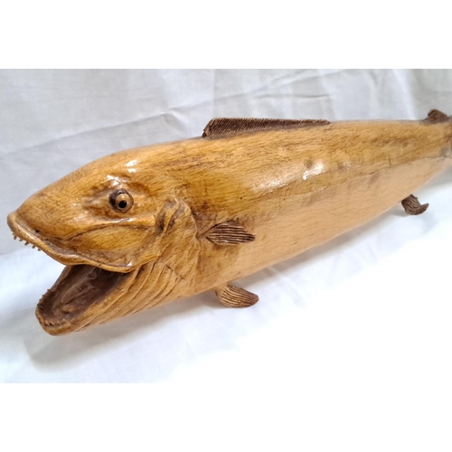 126 - Hand-carved wooden fish sculpture showcases intricate details and polished finish. The piece display... 