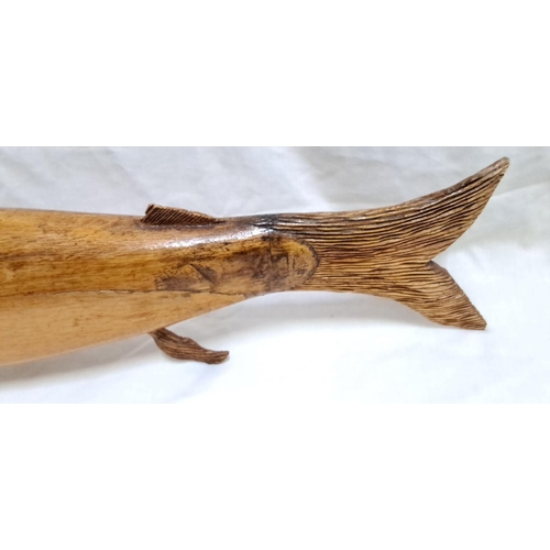 126 - Hand-carved wooden fish sculpture showcases intricate details and polished finish. The piece display... 