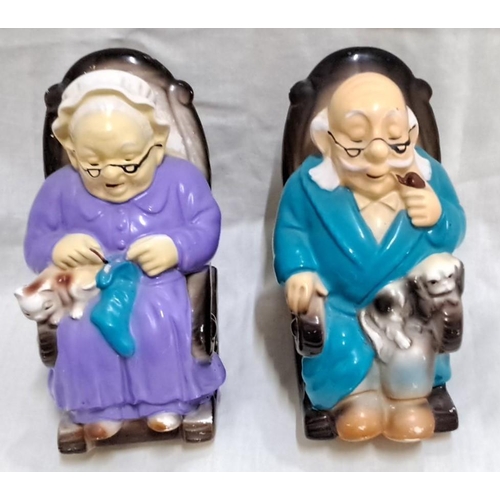 130 - Pair of vintage ceramic figurine banks featuring an elderly couple with pets. Marked 