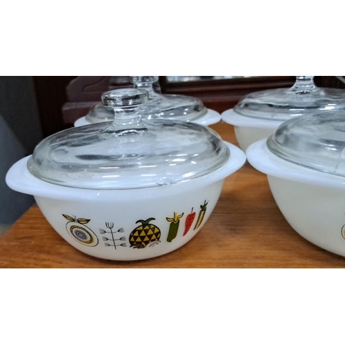 136 - Set of six vintage Pyrex casserole dishes with glass lids, featuring a decorative vegetable print on... 