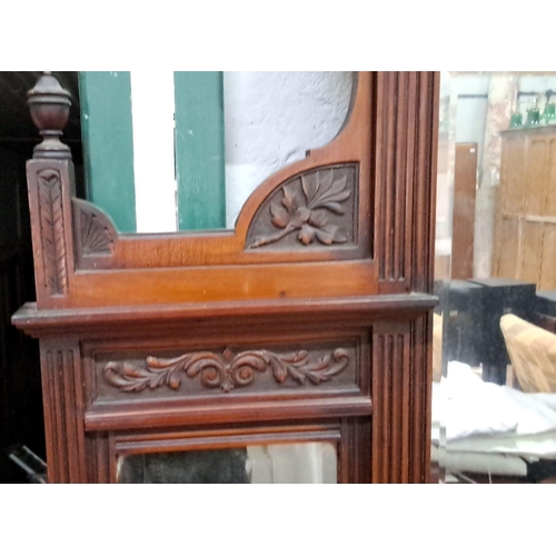 138 - Victorian mahogany overmantel mirror with intricate carvings and side shelves. Features floral and l... 