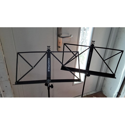 142 - Pair of Essentials black metal folding music stands with tripod bases, adjustable height, and sheet ... 