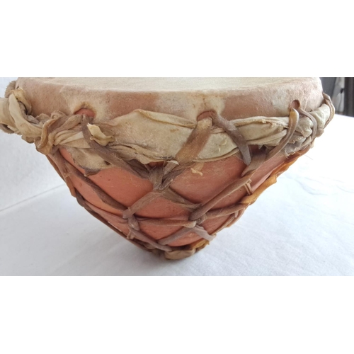 145 - Traditional drum with a natural hide membrane and terracotta base, featuring rustic lacing and a han... 