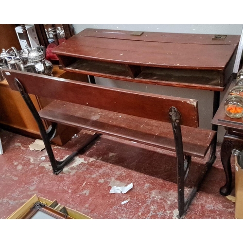 150 - Antique school desk with bench, featuring wooden surfaces and cast iron legs. From early to mid-20th... 