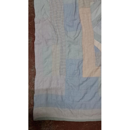 154 - Patchwork quilt in soft blue, beige, and white tones, featuring various fabric patterns and textures... 