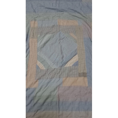 154 - Patchwork quilt in soft blue, beige, and white tones, featuring various fabric patterns and textures... 