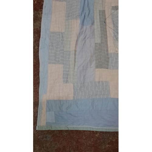 154 - Patchwork quilt in soft blue, beige, and white tones, featuring various fabric patterns and textures... 