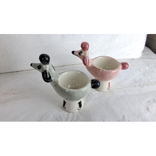 159 - Ceramic kitchenware set includes fish salt and pepper shakers, two poodle egg cups, and a square dis... 