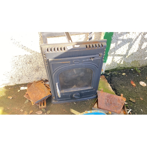 392 - cast iron stove with chrome handle, featuring a functional glass door and additional grill parts.