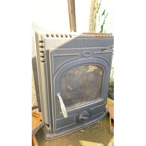 392 - cast iron stove with chrome handle, featuring a functional glass door and additional grill parts.