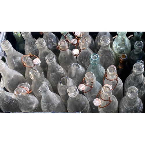 399 - Collection of vintage glass bottles with swing top closures, assorted designs and colours, predomina... 