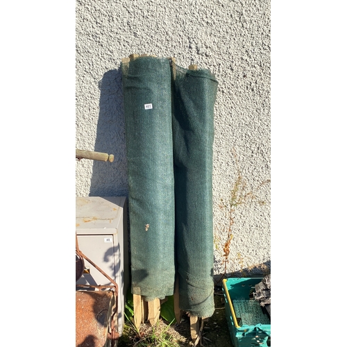 401 - Large mesh fence with wooden posts.