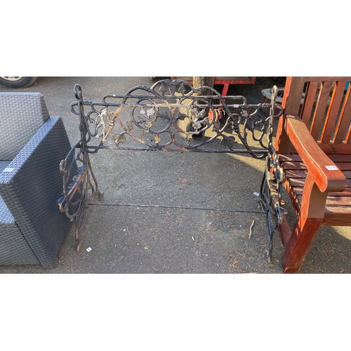 413 - Victorian wrought iron bench frame with intricate floral and vine motifs.