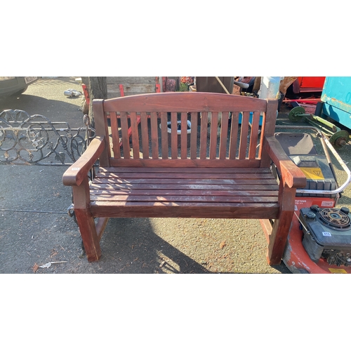 414 - Vintage wooden park bench with slatted back and seat, featuring sturdy armrests and made of a durabl... 